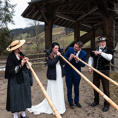 2020-01-17_Eggiwil Hochzeit, die Braut entlockt dem Alphorn einen Ton, zur Freude des Bräutigams.